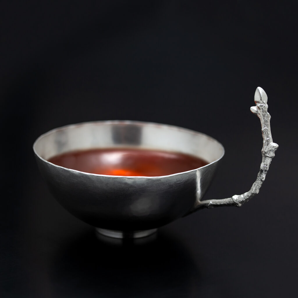 En liten kopp av 830 silver med ett handrag i form av en ek kvist. Tillverkad av Petronella Eriksson. Sista chansen att njuta av "Silverte"!